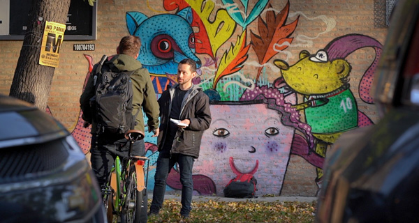 Mauricio Pena interviewing someone on the street