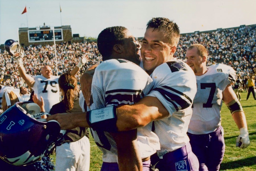 Schnur and a teammate celebrate a Wildcats win in 1995.